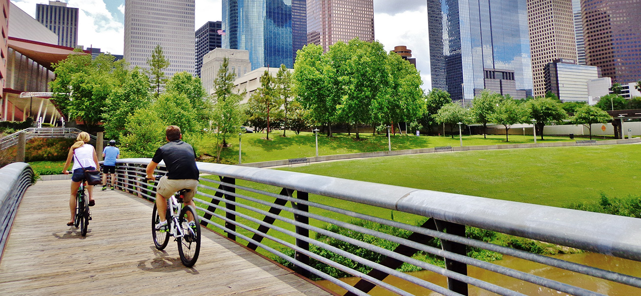 People biking at the Buffalo Bayou Park.